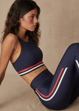 THE UPSIDE Playback 25inch Midi Pant in Navy is a sustainable mid-rise midi pant with printed stripe detail down legs and rubber arrow badge at centre back.