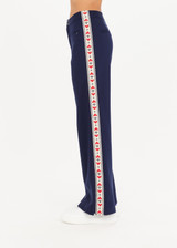 THE UPSIDE Meribel Ria Flare Pant in Navy is a flare pant with zips at hem, zipper pockets and knitted heart tape down sides.