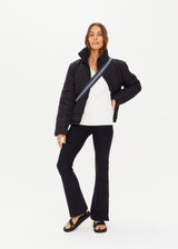 THE UPSIDE women's white Seymour Knit Sweater made with 100% organic cotton cable knit fabrication features a v-shaped neckline, ribbed cuffs, hem and neck, and embroidered arrow logo on back of neck.