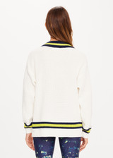 THE UPSIDE Varsity Josie Sweater in Bone is a sustainable organic cotton “V” neck knit sweater with contrasting coloured stripes, soft ribbed cuffs and hem and embroidered varsity TU patch at chest.