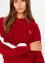 THE UPSIDE Collegiate Gia Crop Hoodie in Red is a cropped hoodie in our monogram TU terry towelling with contrast white tape down sleeves and embroidered arrow badge.