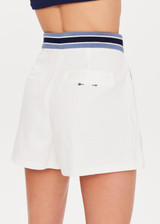 THE UPSIDE Bounce Palmer Short in White is a sustainable organic cotton high waisted short with contrast stripe ribbed waistband, pockets and fly front zipper opening and double button closure.
