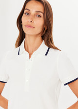 THE UPSIDE Bounce Birdie Crop Polo in White is a sustainable organic cotton cropped polo with a rib collar and sleeve cuffs with a navy edge stripe and button collar opening.