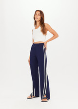 THE UPSIDE Petra Flare in Navy is a flared pant with contrast knitted tape and piping down side seams, splits at front, pockets and elastic at waist.