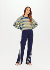 THE UPSIDE Petra Flare in Navy is a flared pant with contrast knitted tape and piping down side seams, splits at front, pockets and elastic at waist.