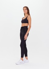 THE UPSIDE women's black Supersoft 25inch Pocket Midi Pant is a mid rise, 7/8 length, super soft legging is made from breathable, quick drying and moisture wicking fabric with a 4-way stretch. It features a stretch drawcord through the waistband and a print arrow at the centre back waistband.