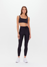 THE UPSIDE women's black Supersoft 25inch Pocket Midi Pant is a mid rise, 7/8 length, super soft legging is made from breathable, quick drying and moisture wicking fabric with a 4-way stretch. It features a stretch drawcord through the waistband and a print arrow at the centre back waistband.