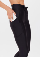 THE UPSIDE women's black Supersoft 25inch Pocket Midi Pant is a mid rise, 7/8 length, super soft legging is made from breathable, quick drying and moisture wicking fabric with a 4-way stretch. It features a stretch drawcord through the waistband and a print arrow at the centre back waistband.