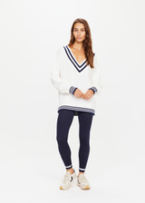 THE UPSIDE womens ivory and navy v-neck Louie Sweater made with organic cotton features a mid-weight knit construction and contrast navy stripes on neckline, cuffs and hems.