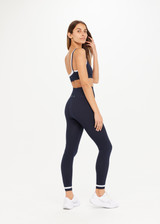 THE UPSIDE womens navy Form Seamless 25in Midi Pant made with Form Seamless fabric features contrast white stripe on ankles, soft ribbed waistband and 25-inch length leg.