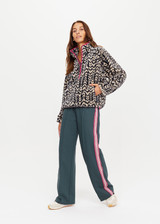 THE UPSIDE womens dark blue abstract pattern Niseko Harlow Pullover made with warm fleece fabric features raglan sleeves, quarter zip, elastic at waist and cuffs, and pink contrasting binds.