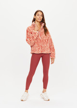 THE UPSIDE womens dark red-brown abstract pattern relaxed Niseko Harlow Pullover made with warm fleece fabrication features printed feathered arrow design, raglan sleeves, quarter zip, and elastic at waist and cuffs.