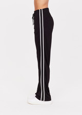 THE UPSIDE women's black Celeste Pant is a relaxed fit, mid rise trackpant with a slinky fabrication. It features a straight leg silhouette, elasticated waistband and drawcord, knitted striped tape down side seams and pockets at the front and back. THE UPSIDE women's black Celeste Pant is a relaxed fit, mid rise trackpant with a slinky fabrication. It features a straight leg silhouette, elasticated waistband and drawcord, knitted striped tape down side seams and pockets at the front and back.