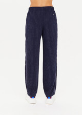 THE UPSIDE women's navy pinstripe Merida Franca Pant made in drapey recycled polyester fabrication features a straight-leg fit, elasticated waist with drawcord, pockets at side seams and solid navy panels frames with striped piping.
