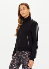 THE UPSIDE women's black slim-fit Realm Margot Jacket made with soft suiting lenzing viscose fabrication features a front zip, functional welt pockets at front, cream piping details, and rib neck, hem and cuffs.