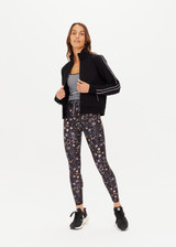 THE UPSIDE women's black slim-fit Realm Margot Jacket made with soft suiting lenzing viscose fabrication features a front zip, functional welt pockets at front, cream piping details, and rib neck, hem and cuffs.