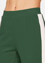 THE UPSIDE women's pine green Petra Flare is a flared pant with splits at front, contrast knitted cream tape down side seams cream tape down the side seams, pockets and elastic at waist.