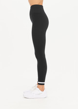 THE UPSIDE women's black mid-rise 25inch legging is made from our form seamless fabric with moisture control properties. It features a soft ribbed waistband and white stripe.
