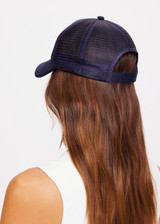 THE UPSIDE women's navy Jetset Trucker Hat is a classic trucker hat with a foam front and mesh back. This lifestyle hat features an adjustable snapper at the back.