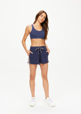 THE UPSIDE women's navy Cascade Zippy Short is made with organic french terry cotton, designed for a relaxed fit. This classic gym short features an elastic drawcord waist.