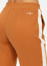 THE UPSIDE women's brown The Banya Petra Flare is made from sustainable lenzing viscose and is a true to size fit. This lifestyle flare pant features white side stripe down the sides, an elastic waist and side seam pockets.