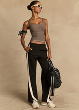 THE UPSIDE women's black Petra Flare is made from a lenzing viscose soft suiting fabrication. The full length tailored pant features side pockets and an elasticated waistband. Designed for walking and recovery.