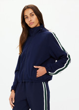 THE UPSIDE women's navy Mansi Dawson Run Jacket is made in a light and breathable recycled fabric, featuring colours of green and white. The run jacket is water resistant and is fitted with elasticated cuffs with inner sleeve gloves and invisible zip pockets and a large back pocket for storing purposes. Designed for golf.