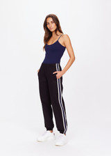 THE UPSIDE women's black Beaufort Cala Zip Pant is made from soft lenzing fabric. The slim fit track pant features contrast white and navy stripe down the sides, elasticated waist and cuffs, invisible zips at cuffs and front and back pockets.