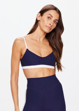 THE UPSIDE women's navy Hamptons Ballet Bra is made from recycled soft peached fabrication with a brushed handfeel and a breathable, quick drying effect. The low coverage ballet bra features elastic straps with adjusters. Designed for yoga and pilates.