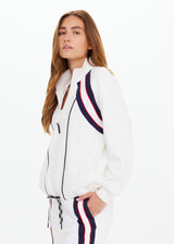 THE UPSIDE women's white Pacific Morgan Zip Jacket is made from organic cotton. The tennis jacket features pockets and drawstring. Designed for tennis and pickleball.
