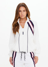 THE UPSIDE women's white Pacific Morgan Zip Jacket is made from organic cotton. The tennis jacket features pockets and drawstring. Designed for tennis and pickleball.