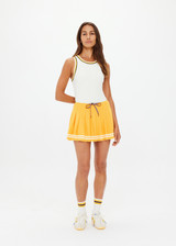 THE UPSIDE women's mimosa yellow recycled fabric Prix Quinny Pleated Skirt features a inner spin short with pockets and elasticated drawcord waist. Made for tennis.
