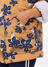 THE UPSIDE women's floral Aruba Quilted Nicola Jacket is designed for an oversized fit and features patch pockets and antique brass zipper. Made for lifestyle.