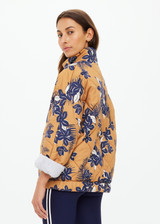 THE UPSIDE women's floral Aruba Quilted Nicola Jacket is designed for an oversized fit and features patch pockets and antique brass zipper. Made for lifestyle.