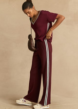 THE UPSIDE women's merlot Sienna V Neck Tee is a retro style slim fit track tee in a lightweight knit and features a deep V neckline. Made for everyday.