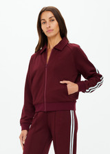 THE UPSIDE women's merlot Vitesse Pari Zip Jacket is a zip through sport jacket in a slinky fabrication with mesh stripes down sides in Mint. Made for lifestyle.