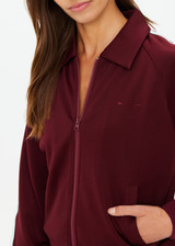 THE UPSIDE women's merlot Vitesse Pari Zip Jacket is a zip through sport jacket in a slinky fabrication with mesh stripes down sides in Mint. Made for lifestyle.