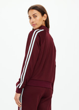 THE UPSIDE women's merlot Vitesse Pari Zip Jacket is a zip through sport jacket in a slinky fabrication with mesh stripes down sides in Mint. Made for lifestyle.