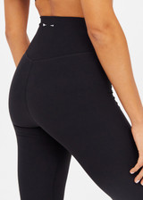 THE UPSIDE women's black Peached Thia Crop Flare is a high-waisted 7/8 length flared pant with a soft folded waistband in recycled peached fabric. Made for yoga & pilates.