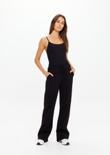 THE UPSIDE women's black organic cotton Willow Wide Leg Pant is a high-waisted, relaxed fit and features an elasticated waistband with drawcord and side seam pockets. Made for lifestyle.