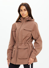 THE UPSIDE women's brown Freddie Fleece Lined Anorak is made from bonded water resistant fabric with internal warm polar fleece and features external pockets with flap closure and drawcord with toggles to cinch in waist.