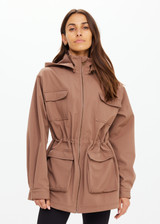 THE UPSIDE women's brown Freddie Fleece Lined Anorak is made from bonded water resistant fabric with internal warm polar fleece and features external pockets with flap closure and drawcord with toggles to cinch in waist.