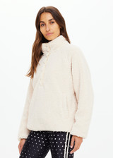 THE UPSIDE women's natural Harlow Fleece Pullover offers a relaxed fit made from recycled warm fleece fabric and features zip pockets and an elastic at waist and cuffs to keep warmth in. Made for lifestyle.