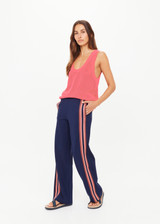 THE UPSIDE women’s navy Ananda Wide Leg Cody Pant is a true-to-size fit and features an elasticated waistband, side pockets and knitted stripes down sleeves. The perfect everyday piece.