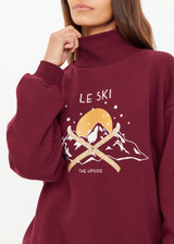 THE UPSIDE women’s maroon organic cotton Le Ski Clementine Crew is designed for an oversized fit and features Le Ski logo print & embroidery on front chest. Designed for Après-ski and winter wear.