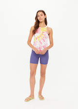 THE UPSIDE women's tie-dye organic cotton Asher Racerback Tank Top features hand tie-dyed tropical shades of pink, red, and yellow on a white base. Made for lifestyle.