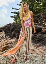 THE UPSIDE women's tie-dye organic cotton Asher Racerback Tank Top features hand tie-dyed tropical shades of pink, red, and yellow on a white base. Made for lifestyle.