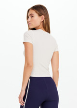 THE UPSIDE women’s cream Shelter Fitted Tee is designed for a soft & comfortable fit and features an embroidered arrow logo at the back of neck. The perfect everyday tee.