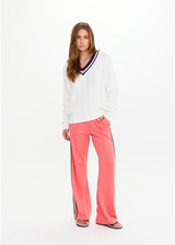 THE UPSIDE women’s cream organic cotton Espada Louie V Neck Sweater is a regular, chunky cable knit design with a navy and rose striped neckline. Made for everyday.