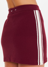 THE UPSIDE women’s recycled maroon Adesa Zelma Knit Mini Skirt features a cream stripe along the side. Made for lifestyle.